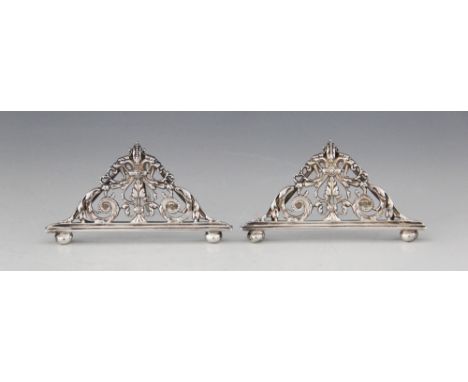 A pair of George V silver menu holders, William Hutton &amp; Sons, Sheffield 1911, each of triangular form with pierced folia