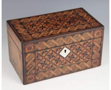 A late 19th century walnut and parquetry tea caddy, the hinged top inlaid with repeating geometric motifs and banding, openin