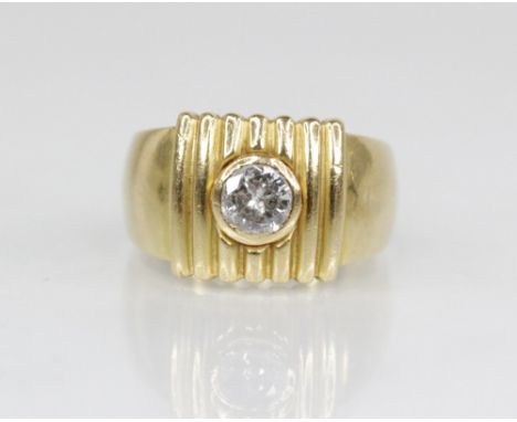 A diamond solitaire 18ct gold ring, the central round brilliant cut diamond weighing approximately 0.35 carats, bezel set to 