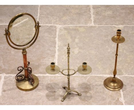 An early 20th century copper and brass pedestal vanity swing mirror, the bevelled oval mirrored plate raised upon a telescopi