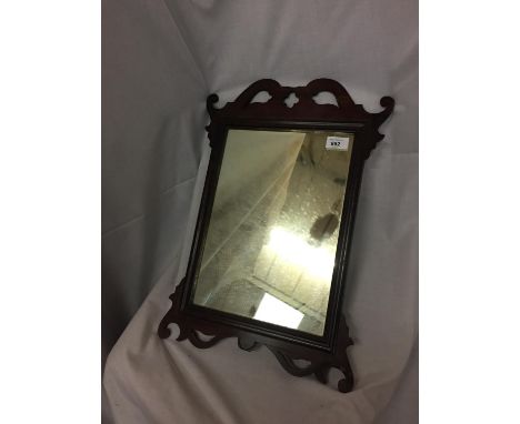 A VINTAGE WOOD FRAMED MIRROR 