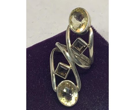 A LARGE SILVER DESIGNER RING ON A TWSIT DESIGN WITH FOUR VARIOUS STONES SIZE R 