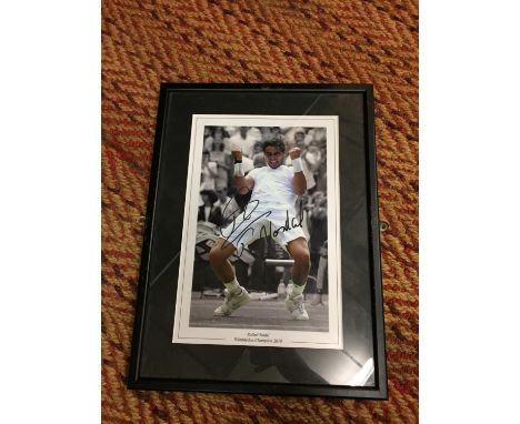 A FRAMED SIGNED PRINT OF RAFAEL NADAL 