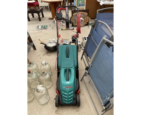 AN ELECTRIC BOSCH ROTAK 32 R LAWN MOWER WITH GRASS BOX IN WORKING ORDER BUT NO WARRANTY GIVEN 