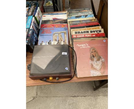 A SMALL RECORD PLAYER AND AN ASSORTMENT OF VINTAGE LP RECORDS 