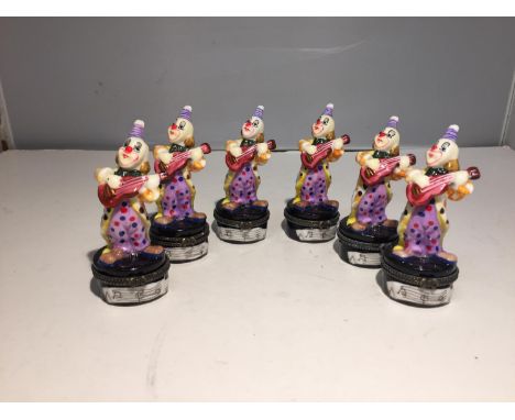 SIX TRINKET BOXES EACH WITH A GLASS CLOWN PLAYING GUITAR FIGURE 