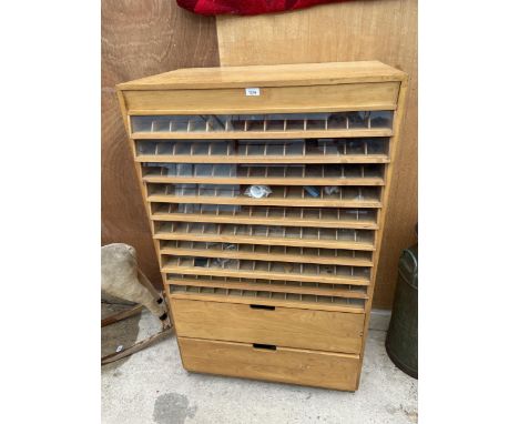 A VINTAGE MACHINIST'S HABERDASHERY CABINET ENCLOSING TWELVE VARIOUS SECTIONAL DRAWERS 