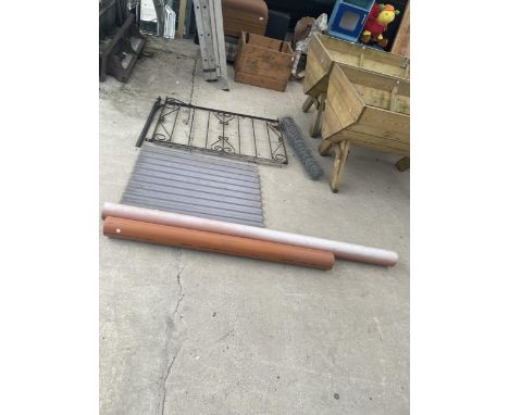 A WROUGHT IRON GATE AND POST, WIRE NETTING, PERSPEX SHEETS AND TWO DRAIN PIPES 