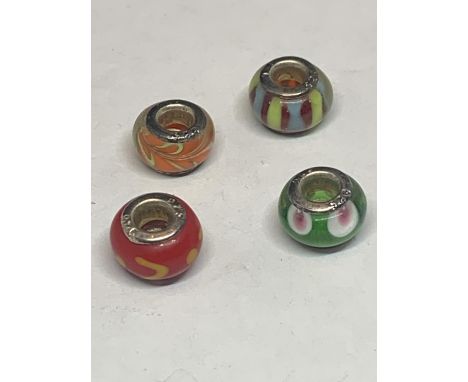 FOUR SILVER AND GLASS BEAD CHARMS 