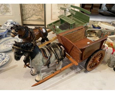 TWO CERAMIC HORSES WITH WOODEN CARTS 