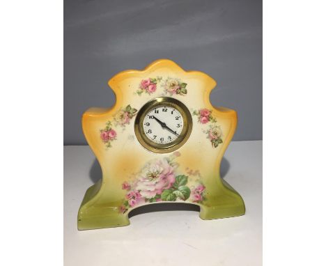 A DECORATIVE CERAMIC MANTLE CLOCK WITH A DELICATE ROSE DESIGN 
