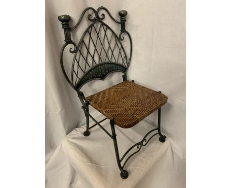 A VINTAGE VERY HEAVY WROUGHT IRON CHILDRENS CHAIR WITH A WOVEN SEAT 