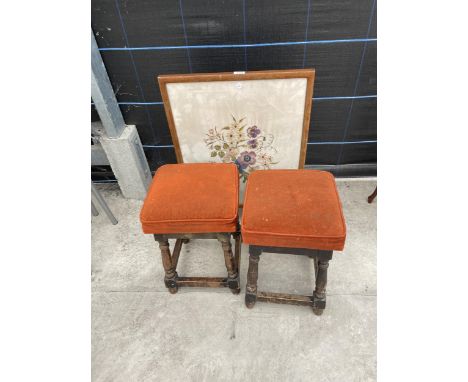 AN OAK FOLDING TABLE/FIRESCREEN WITH WOOLWORK DEPICTING FLOWERS AND TWO STOOLS 