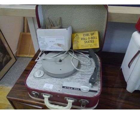 A 1960's Alba child's portable record player; together with a boxed set of Burtoys Curl Up Roll-a-Doll skates and a painted w