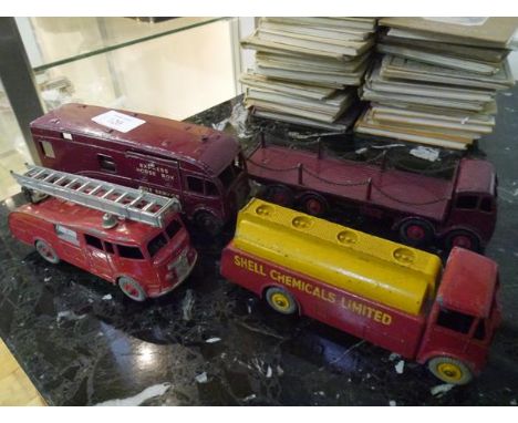 A group of Dinky model vehicles comprising: a Foden flat truck with chains in maroon no. 505; an "Express" horse box no. 581;