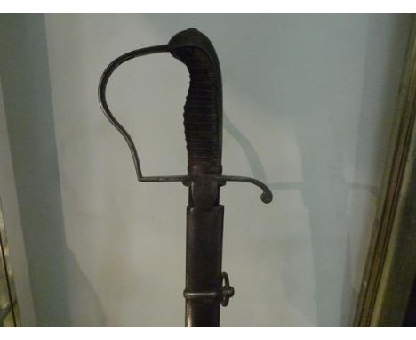 A cavalry trooper's sword, probably German, 19th century, with curved shallow fullered blade and steel stirrup hilt, in a ste