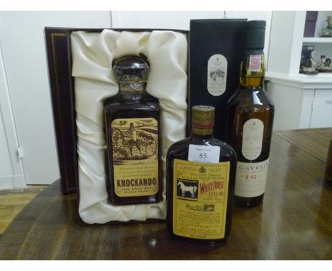 Three Scotch whiskies: Knockando Extra Old pure single malt, boxed with presentation label; Lagavulin single Islay Malt, aged