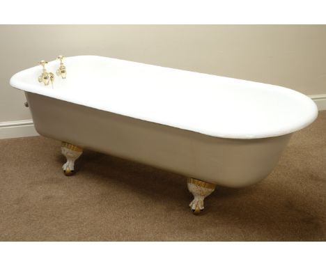 Early 20th century cast iron roll top enamel bath, brass finish taps, on painted and gilt ball and claw feet, L180cm   Condit