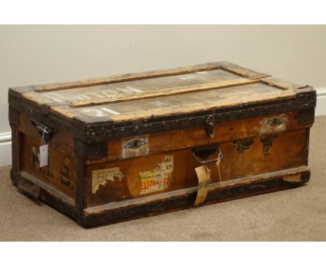 Early 20th century wooden and metal bound travelling trunk, zinc lined, with travel labels, W92cm, H34cm, D54cm   Condition R