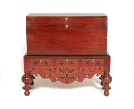 AN INDO DUTCH MAHOGANY TRUNK ON STAND
19th Century 
The rectangular trunk with hinged cover, the stand fitted with three draw