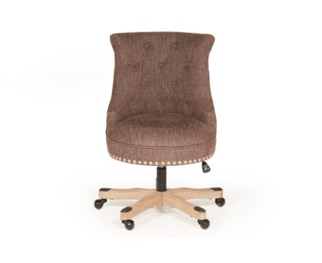 AN UPHOLSTERED OFFICE CHAIR
Grey upholstered fabric with a button back and metal button studded decoration around the base of