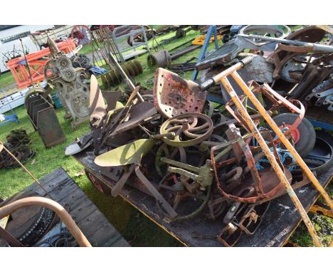 Large Mixed Lot: Various iron wares to include wheels, plough furrows, unbranded tractor seat, silage knives etc