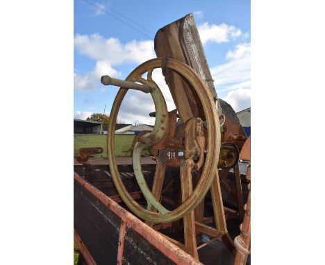 A green painted cast iron oil cake breaker, model number E60