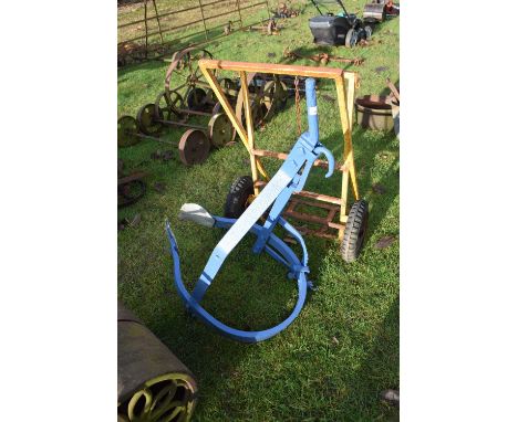 A blue painted iron tractor attachment