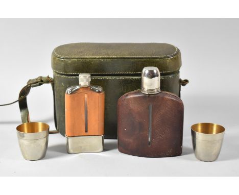 A Mid 20th Century Oval Leather Case Containing Two Hip Flasks and Two Silver Plated Cups, 22cm wide 