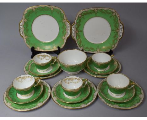 A Crown Staffordshire Green and Gilt Decorated Tea set to comprise Slop Bowl, Two Cake Plates, Five Cups, Seven Saucers, Five