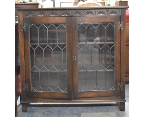 An Oak Lead Glazed Two Shelf Bookcase with Carved Top Rail, 94cm wide 