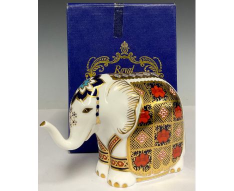 A Royal Crown Derby paperweight, Imari Elephant, decorated in the 1128 pattern, trunk raised, gold stopper, 11cm, printed mar