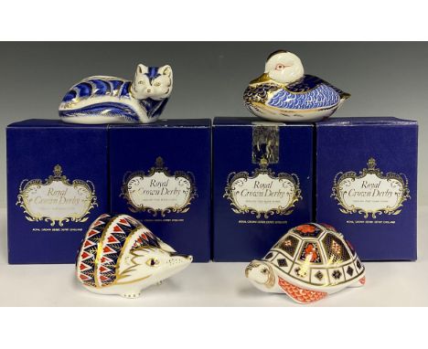 A Royal Crown Derby paperweight, Hedgehog, gold stopper, 11cm long, boxed; others, Tortoise, decorated in the 1128 pattern, g