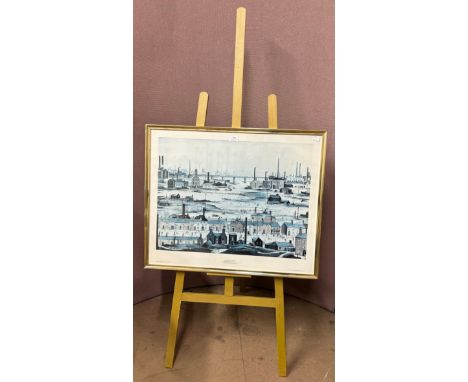 An L.S. Lowry print on an artists easel 