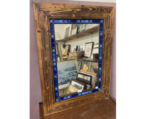 An oak framed stained glass mirror 