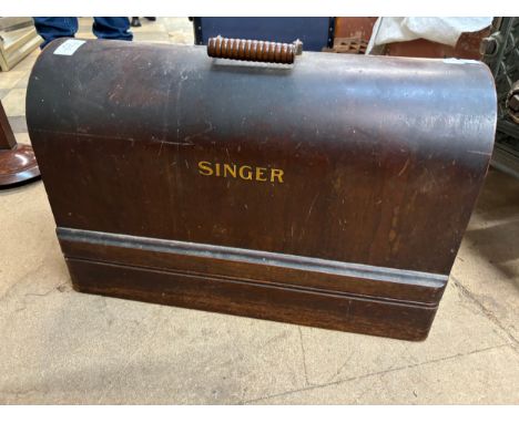 A cased Singer sewing machine (locked and without key) 