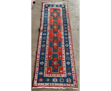 A Turkish red ground runner rug, 83 x 247cms