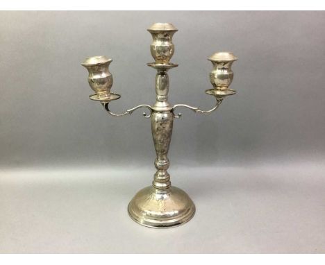 SILVER TWO BRANCH CANDLESTICK the scrolling branches eithe side of the tapering body, marked 92533.1cm high 