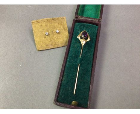 PAIR OF NINE CARAT GOLD AND DIAMOND STUD EARRINGS AND A YELLOW METAL STICK PIN the stick pin set with purple coloured stone