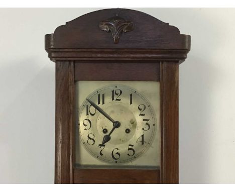 LATE 19TH CENTURY OAK WALL CLOCK AND A MANTEL CLOCK the oak wall clock with a scroll decorated top, along with an Art Deco ma