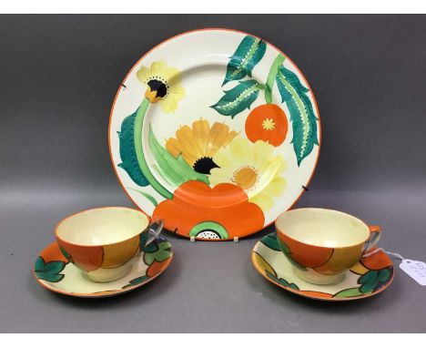 SUSIE COOPER FOR GRAYS POTTERY TWO CUPS AND SAUCERS ALONG WITH A SIMILAR PLATE each piece decorated with floral displaysplate