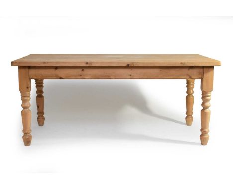 A recent pine kitchen table, the plain top above a plain frieze, raised on turned baluster supports, 183cm wide x 89.5cm deep