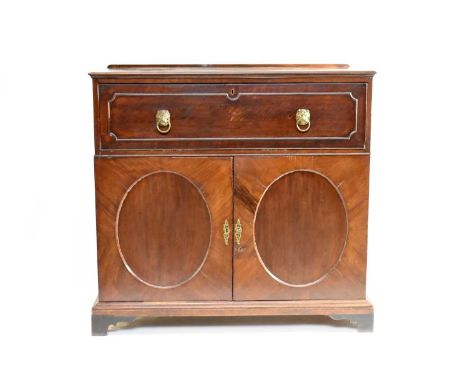 A George III mahogany secretaire cabinet, the moulded top above a panelled fall front having brass lion head handles, opening