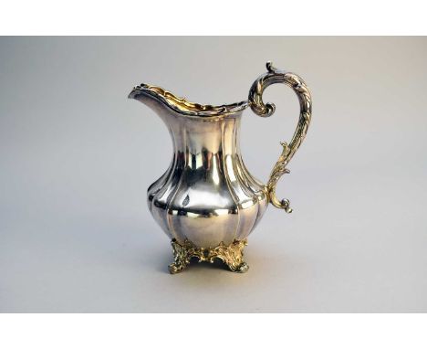 An early Victorian silver cream jug, Barnard Brothers, London 1837, of baluster form with acanthus leaf capped handle, gilt i