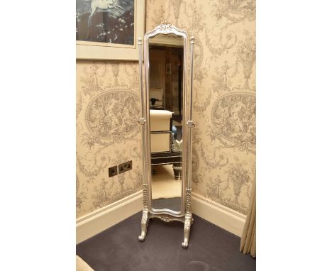 A reproduction silver coloured carved wood cheval mirror, with floral and foliate decoration, raised on scroll feet. 164cm hi