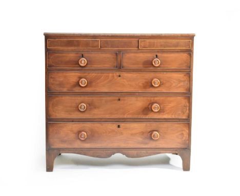 A 19th century inlaid mahogany chest of drawers, the cross-banded and line inlaid top above two concealed frieze drawers with