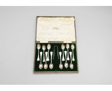 A cased set of twelve stylised trefid silver teapsoons with sugar tongs, Fenton Brothers Ltd, Sheffield 1911, within original