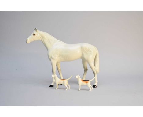 A large Beswick grey racehorse, gloss, printed factory mark, 28cm high together with two Beswick hunting hounds, 7.5cm high (