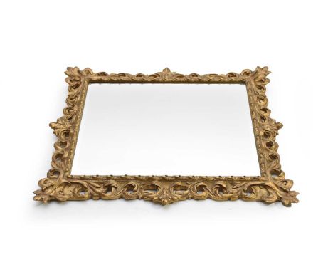A giltwood and composite wall mirror, 20th century, the bevelled rectangular plate within a moulded openwork frame with scrol