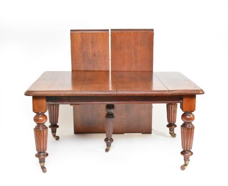 A Victorian mahogany wind-out dining table, the moulded top above a plain frieze with moulded edge, raised on turned reeded b